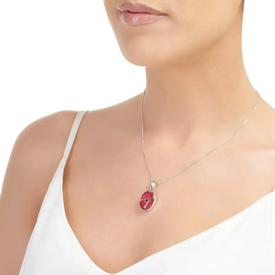 Poppy necklace by Shrieking Violet® Sterling silver oval pendant handmade with a single mini poppy (Euphorbia milii).